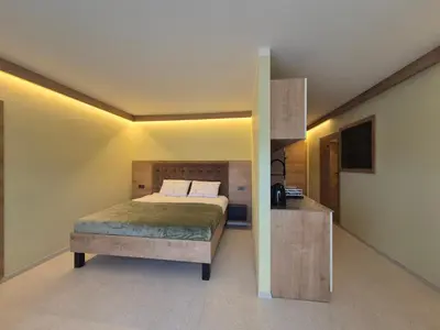 a small bedroom with a bed and a counter at Mega Apartmaji in Rogaška Slatina