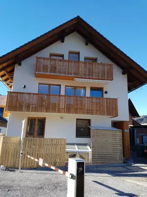 a house with wooden balconies on top of it at Apartment Brina in Kranjska Gora