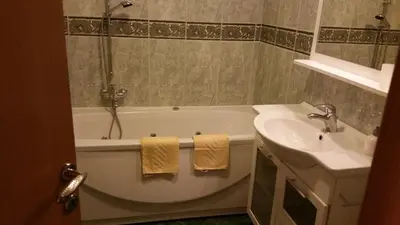 a bathroom with a bath tub and a sink at Apartment Brina in Kranjska Gora