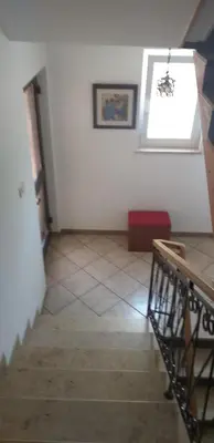 a room with a staircase and a window on the wall at Love 2 Solkan in Nova Gorica