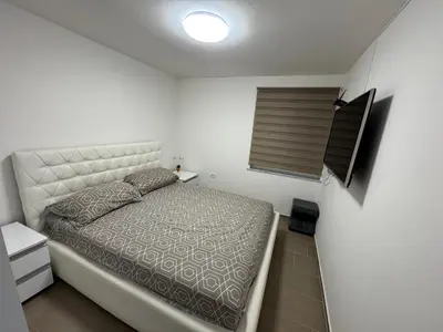 a small bedroom with a bed and a window at Koper apartma okolica in Koper