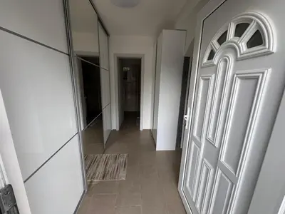 a hallway with a door and a tile floor at Koper apartma okolica in Koper