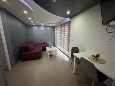 a living room with a red couch and a table at Koper apartma okolica in Koper
