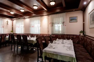 a restaurant with two tables and chairs with white table cloth at Hotel Florjančkov Hram in Ljubljana