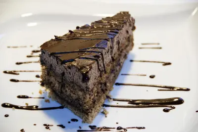 a piece of chocolate cake on a white plate at Hotel Florjančkov Hram in Ljubljana