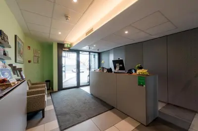 an office with a reception desk in a building at Hotel Florjančkov Hram in Ljubljana