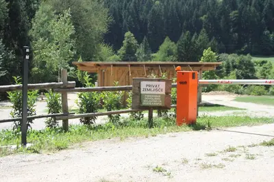 a wooden fence with a sign in front of a building at Outsidersi Campsite