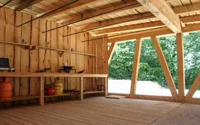 a large wooden barn with a large window at Outsidersi Campsite
