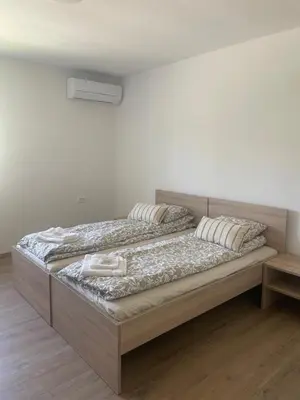 two beds in a white room with two pillows at VP sobe in Ilirska Bistrica