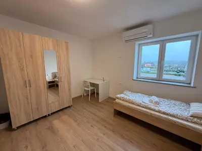 a bedroom with a bed and a cabinet and a window at VP sobe in Ilirska Bistrica