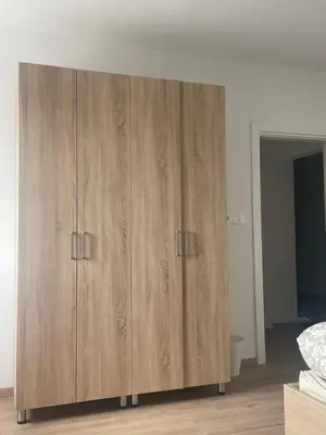 a wooden cabinet with two doors in a bedroom at VP sobe in Ilirska Bistrica