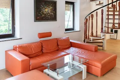 a living room with a couch and a glass table at BIG DUPLEX Terrace FREE PARKING City Center in Ljubljana