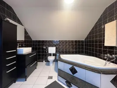 a bathroom with a tub and a toilet at BIG DUPLEX Terrace FREE PARKING City Center in Ljubljana