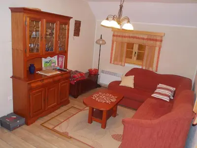 a living room with a couch and a table at Holiday House Kaja in Mojstrana