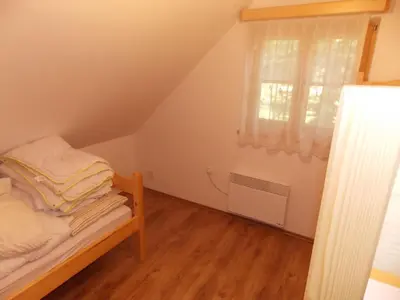 a small bedroom with a bed and a window at Holiday House Kaja in Mojstrana
