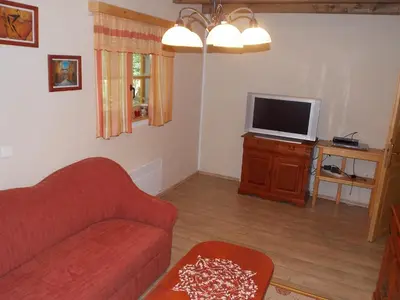 a living room with a couch and a tv at Holiday House Kaja in Mojstrana