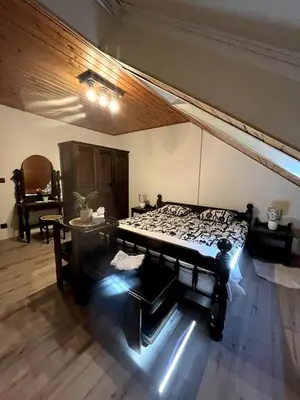 a room with a bed and a table and a piano at Bled Lakeview Apartment Elizabeth in Bled