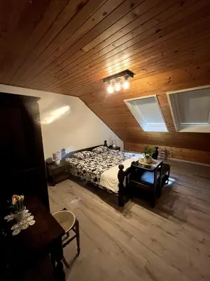 a bedroom with a bed and a table in a room at Bled Lakeview Apartment Elizabeth in Bled
