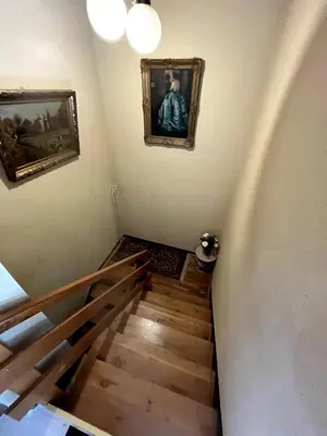 a stairway with two pictures on the wall and a painting at Bled Lakeview Apartment Elizabeth in Bled