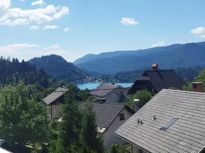 a view of a town with a lake and mountains at Bled Lakeview Apartment Elizabeth in Bled