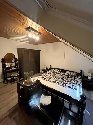 a bedroom with a large bed and a table at Bled Lakeview Apartment Elizabeth in Bled