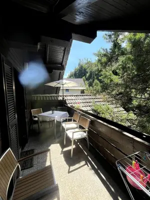 a balcony with a table and chairs and an umbrella at Bled Lakeview Apartment Elizabeth in Bled