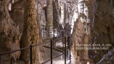 a walkway in a cave with a rock wall at Studio apartment in nature with sauna in Postojna