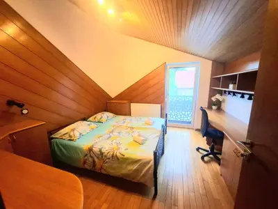 a bedroom with a bed and a desk and a desk at Rooms Lublana in Ljubljana
