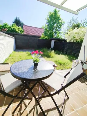 a table with a vase of flowers on a patio at Rooms Lublana in Ljubljana