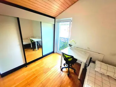 a room with a desk and a table with a couch at Rooms Lublana in Ljubljana