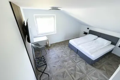 a small bedroom with a bed and a window at Sleepoteca in Šentilj