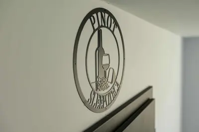 a sign on a wall with a mirror on it at Sleepoteca in Šentilj