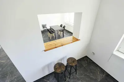 a room with two chairs and a table and a mirror at Sleepoteca in Šentilj