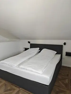 a bed with two white pillows on top of it at Sleepoteca in Šentilj