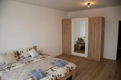 a bedroom with a large bed and a large mirror at Vila Altura- Luxury Hiltop Retreat with Panoramic View & Teracce in Rogaška Slatina