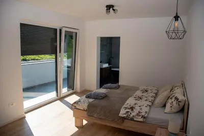 a bedroom with a bed and a large window at Vila Altura- Luxury Hiltop Retreat with Panoramic View & Teracce in Rogaška Slatina