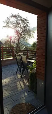 two benches sitting on a patio with a fence at Apartma BoMa in Bovec