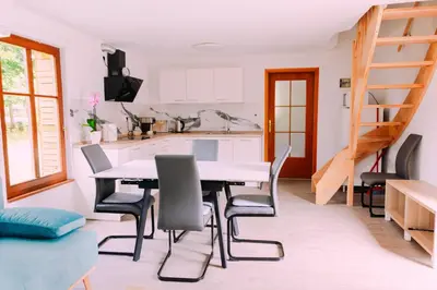a kitchen and dining room with a table and chairs at Apartma BoMa in Bovec