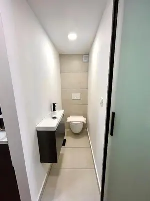 a small bathroom with a toilet and a sink at K-12 Loft Apartments in Ljubljana