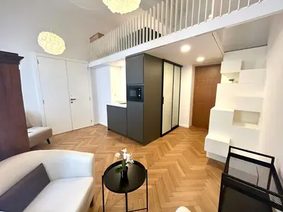 a living room with a white couch and a table at K-12 Loft Apartments in Ljubljana