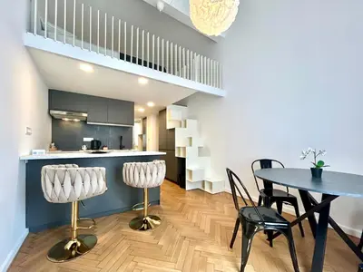 a kitchen and dining room with a table and chairs at K-12 Loft Apartments in Ljubljana