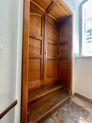 a wooden door in the corner of a room at K-12 Loft Apartments in Ljubljana