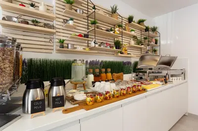 a kitchen with a counter with plants on shelves at Vila Slovenka in Celje