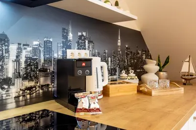 a coffee machine on a counter in a room with a city at Vila Slovenka in Celje