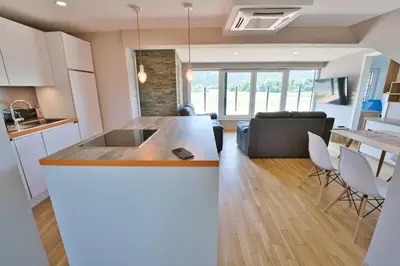 a kitchen and living room with a kitchen island in a room at Apartma Mars in Brest