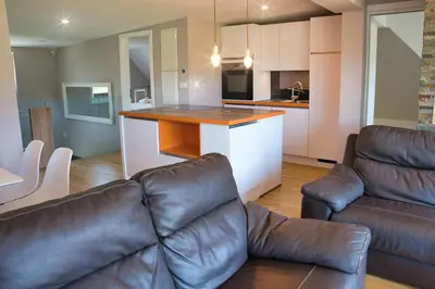 a living room with a couch and a kitchen at Apartma Mars in Brest