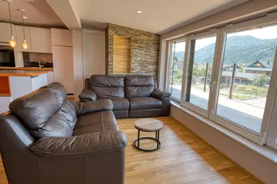 a living room with a leather couch and a table at Apartma Mars in Brest