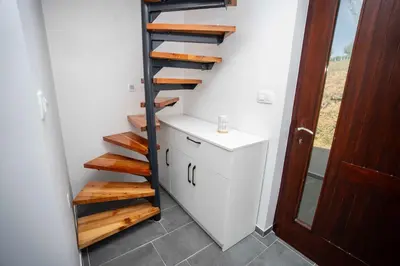 a stairway in a room with a white wall at Holiday House Konuško in Šmarje pri Jelšah
