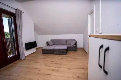 a living room with a couch and a tv at Holiday House Konuško in Šmarje pri Jelšah