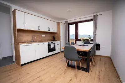 a kitchen and dining room with a table and chairs at Holiday House Konuško in Šmarje pri Jelšah